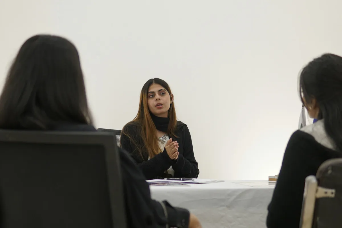 A young woman facilitating a workplace mental health training session